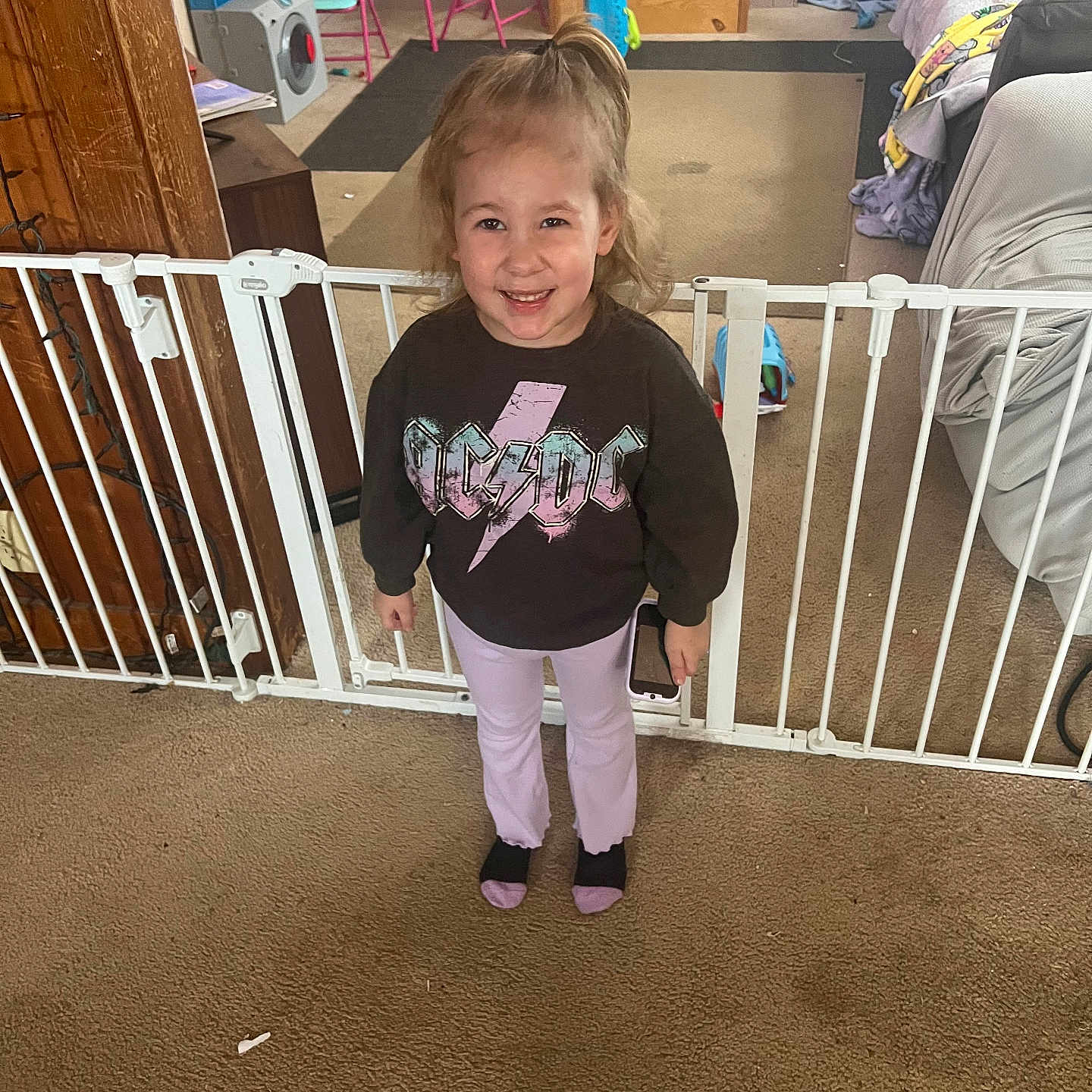 Riley is registered to the contest to win money with this photo: adult, chair, child, clothing, crib, face, female, furniture, girl, head, indoors, infantbed, male, man, pants, person, photography, portrait, standing, t_shirt