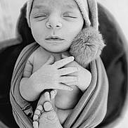 Marius a rejoint le concours — aidez-le/la à gagner de superbes lots ! newborn, baby, infant, sleeping, hat, pompom, swaddle, blanket, feet, hands, portrait, black_and_white, monochrome, closeup, cozy, soft_texture, bucket, wooden_floor, studio_photography, peaceful