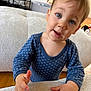 toddler, child, blue_onesie, polka_dots, curious, indoor, couch, hand, face, portrait, young_child, expression, eyes, skin, hair, home, furniture, floor, person, baby