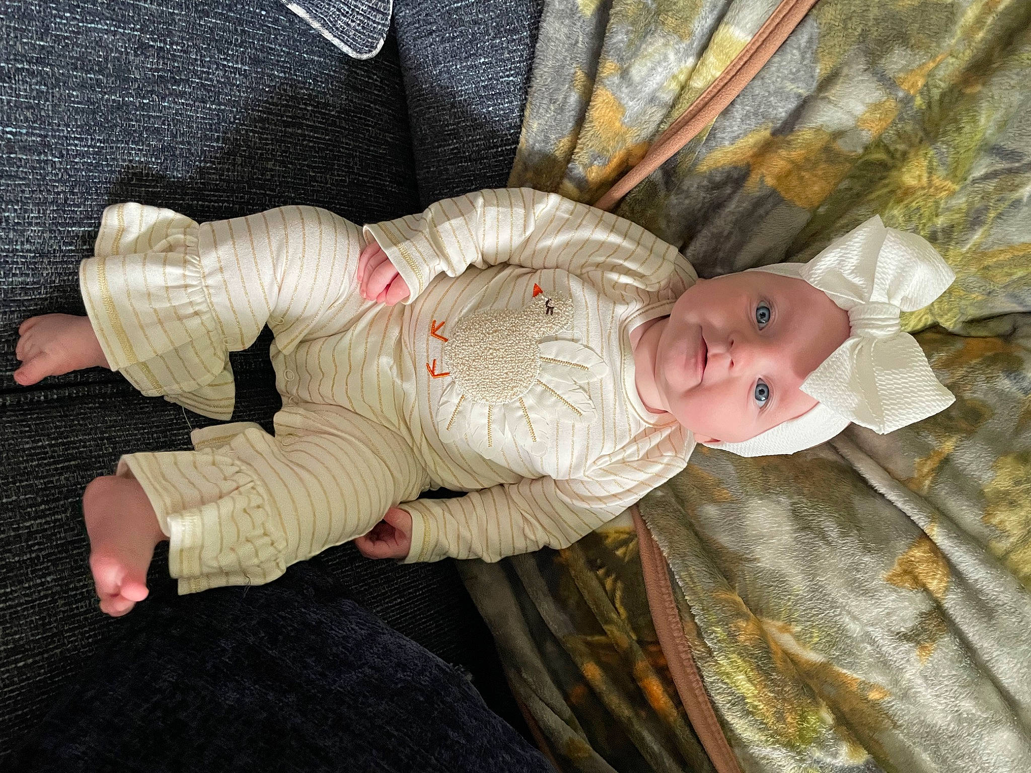 Maci is registered to the contest to win money with this photo: baby, baby_products, baby_toddler_clothing, baby_toys, cheek, child, comfort, doll, headwear, lap, pattern, person, product, sitting, sleep, smile, stuffed_toy, toddler, toy, wood