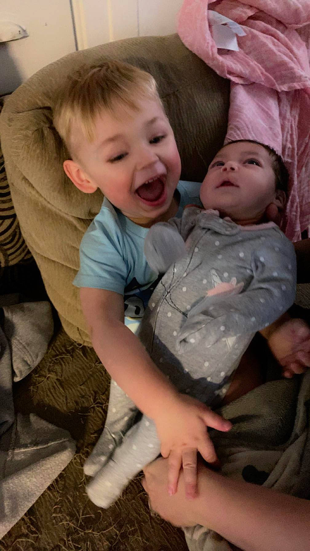 Aiden is registered to the contest to win money with this photo: baby_toddler_clothing, cheek, comfort, facial_expression, finger, fun, happy, human, human_body, iris, lap, mammal, mouth, organ, person, skin, sleeve, smile, standing, t_shirt