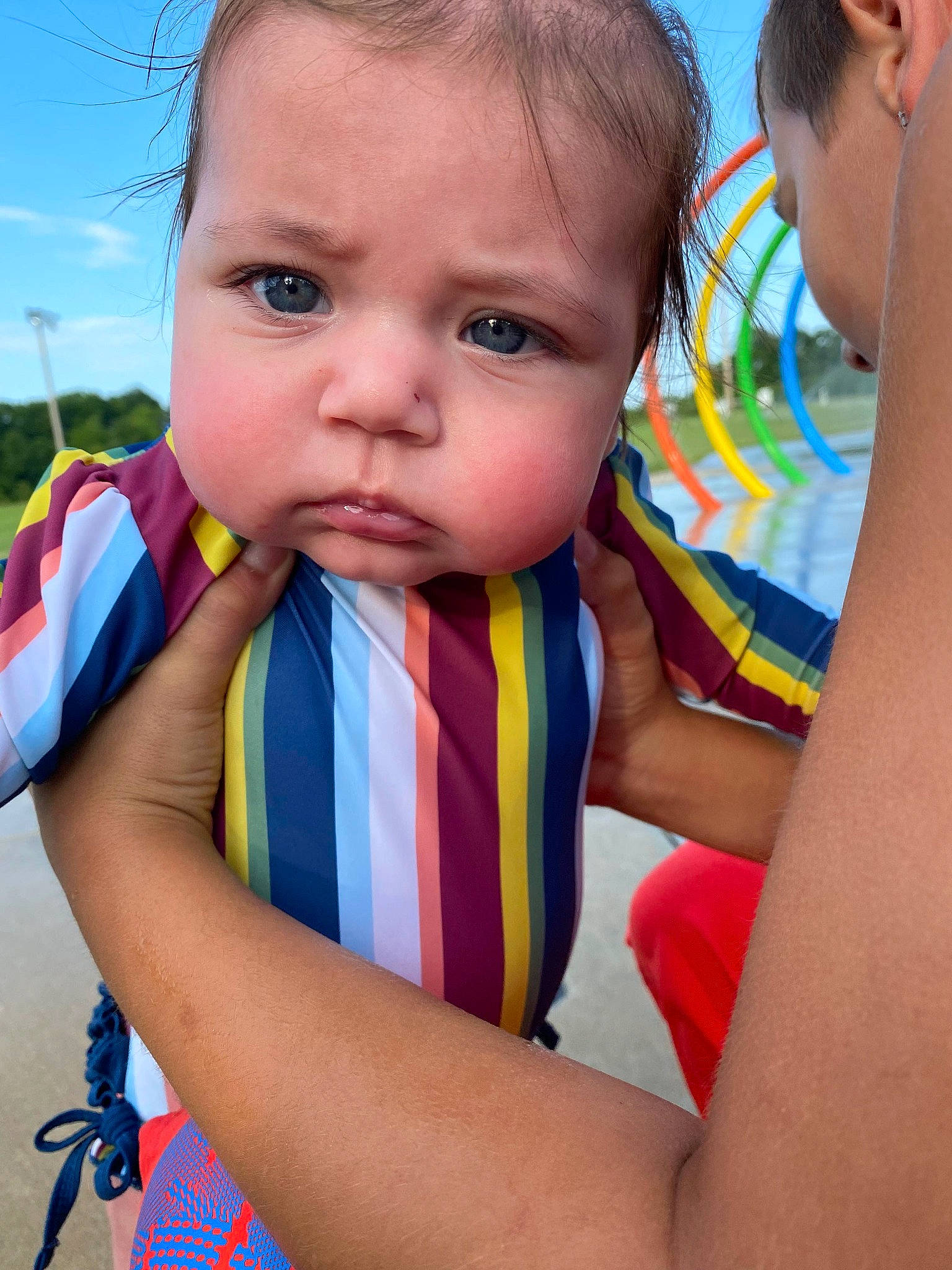 Mary is registered to the contest to win money with this photo: arm, child, chin, facial_expression, finger, fun, gesture, grass, happy, head, human_body, iris, leisure, neck, nose, person, product, recreation, skin, sky