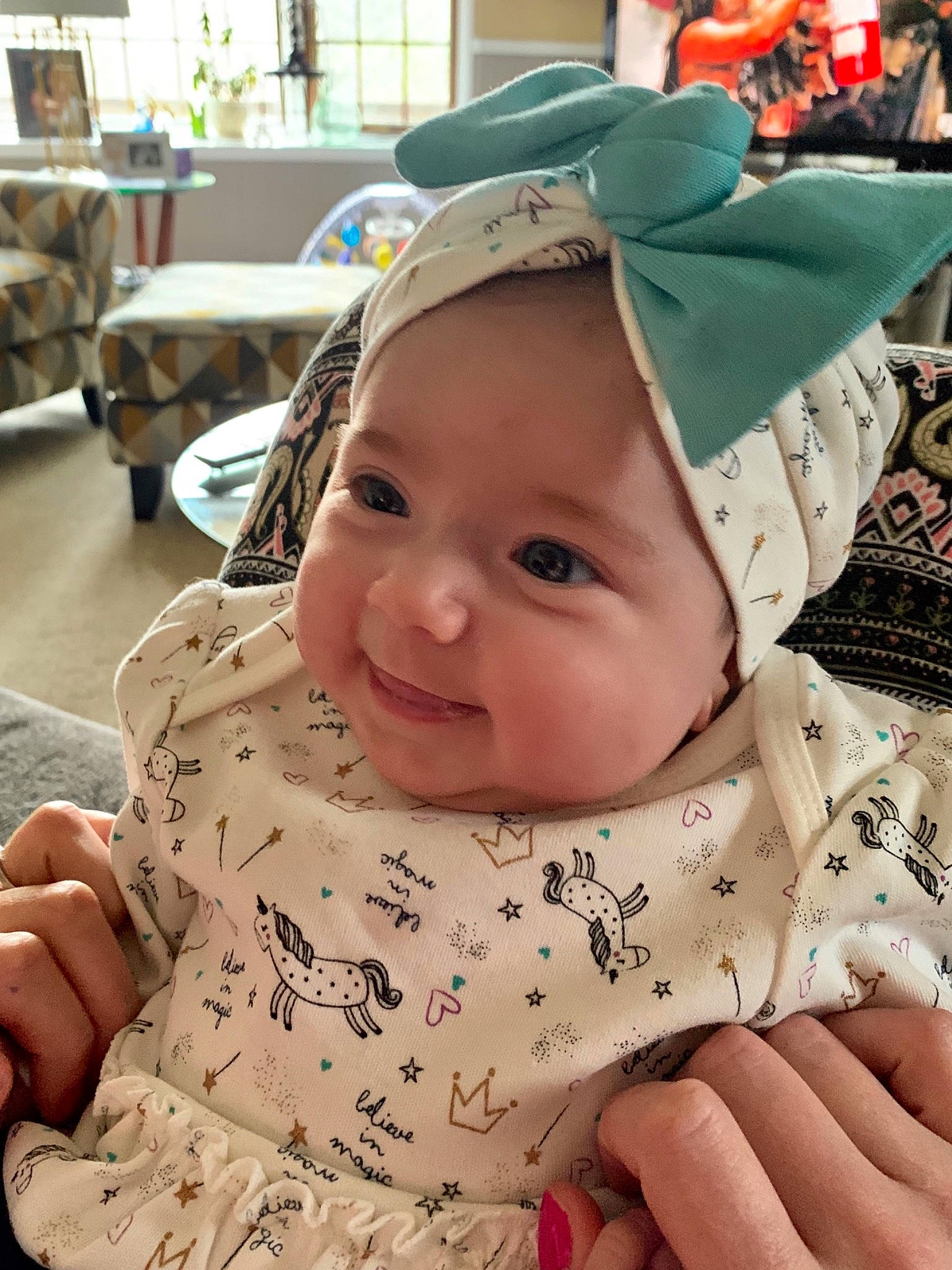 Kilani is registered to the contest to win money with this photo: baby, bonnet, cap, cheek, child, ear, face, fashion_accessory, hat, head, headgear, outerwear, person, skin, smile, sun_hat, toddler