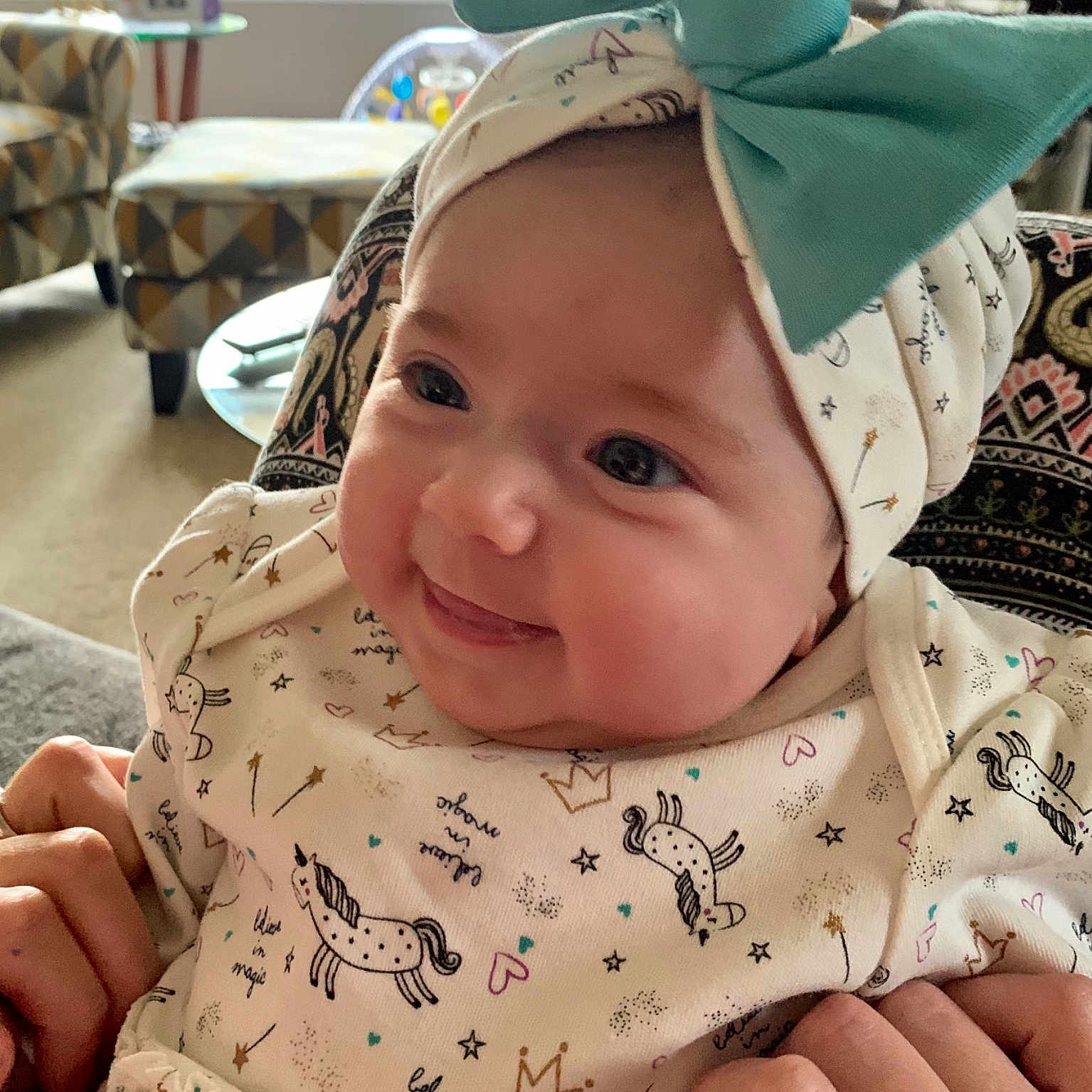 Kilani is registered to the contest to win money with this photo: baby, bonnet, cap, cheek, child, ear, face, fashion_accessory, hat, head, headgear, outerwear, person, skin, smile, sun_hat, toddler