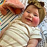 baby, child, smile, headband, bow, cheeks, striped_shirt, pink_pants, blanket, toy, soft_toys, infant, cute, portrait, lying_down, happy, indoors, close_up, face, person