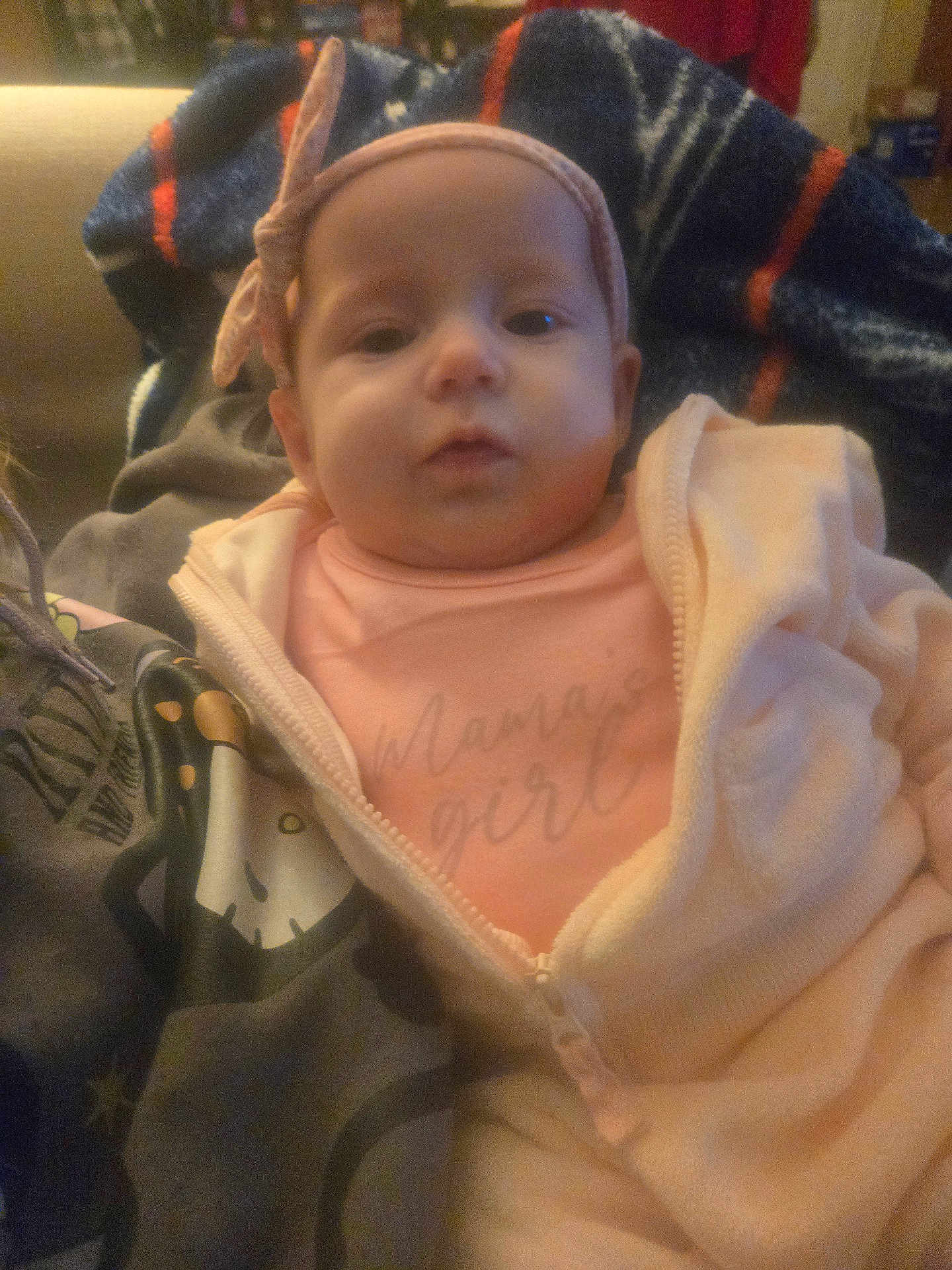 Luna is registered to the contest to win money with this photo: baby, infant, headband, clothing, blanket, indoor, face, person, cute, child, soft, warm, pink, jacket, sitting, portrait, young, cozy, expression, comfort