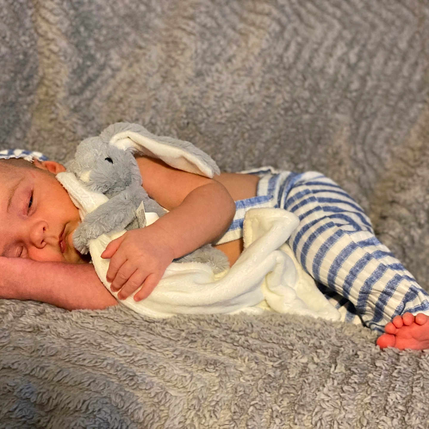 Parker-Lee is registered to the contest to win money with this photo: baby, blanket, bunny, child, comfort, cozy, cute, foot, hand, hat, indoors, infant, peaceful, plush_toy, portrait, resting, sleeping, soft_texture, striped_clothing, toddler