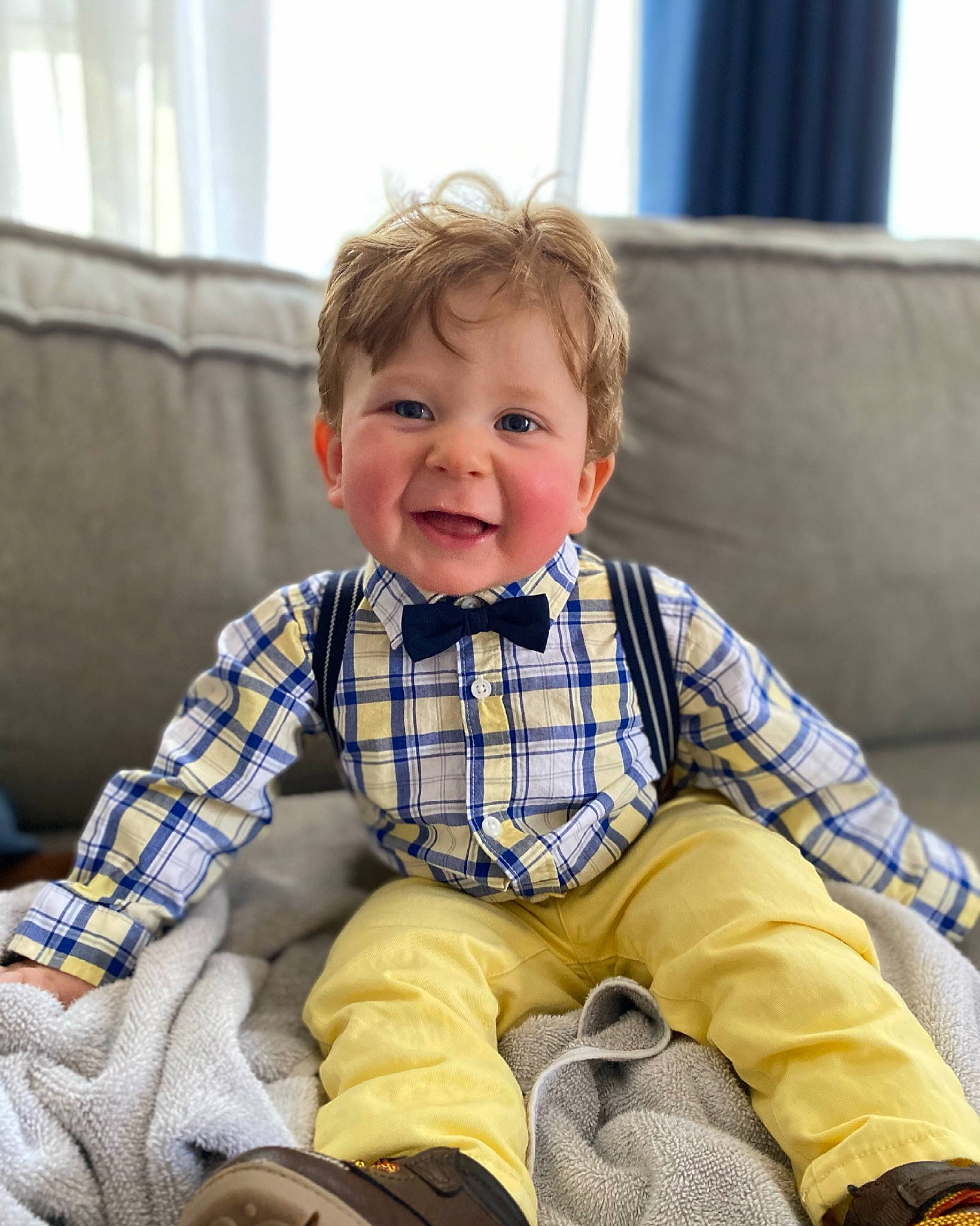 Theodore is registered to the contest to win money with this photo: baby, baby_toddler_clothing, child, chin, comfort, couch, curtain, eye, face, fun, hairstyle, happy, lap, person, plaid, skin, sleeve, smile, tartan, toddler