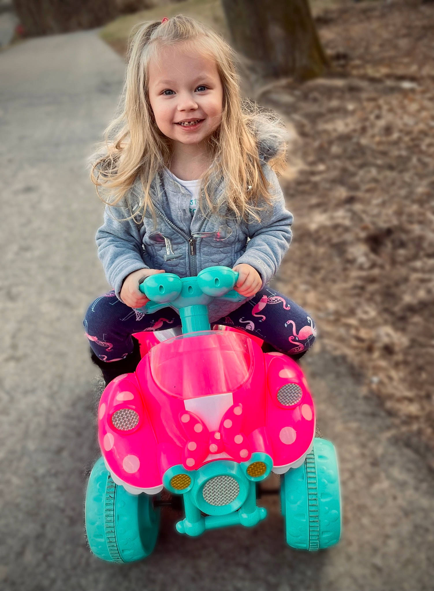 Rayah is registered to the contest to win money with this photo: child, eye, face, fun, grass, hair, happy, head, joy, leisure, motor_vehicle, people, person, photograph, pink, riding_toy, smile, tire, toddler, toy