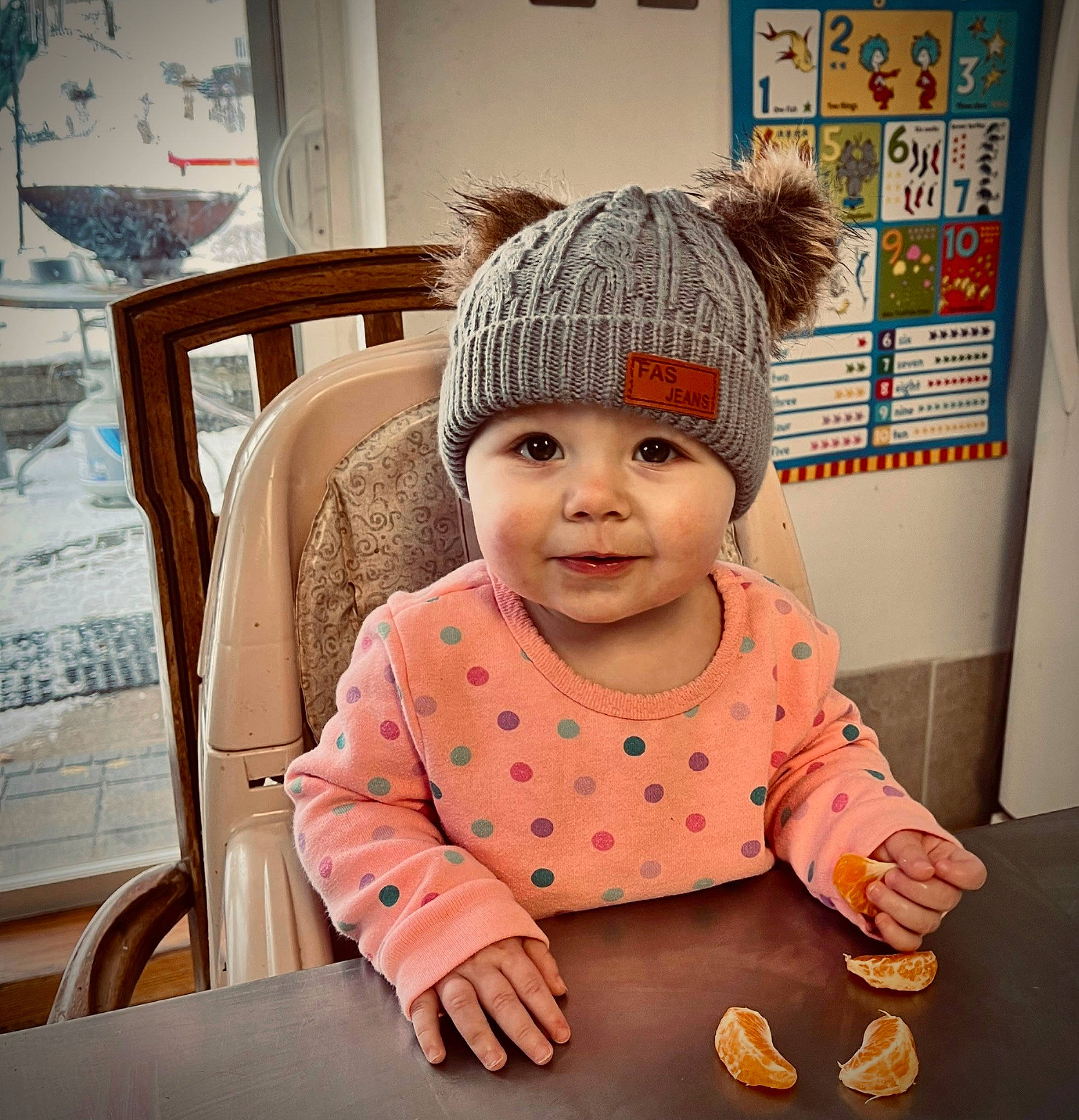 Aryah joined the competition — help win amazing prizes! baby, baby_toddler_clothing, beanie, cap, chair, child, fashion_accessory, flooring, fun, happy, headgear, headwear, joy, knit_cap, peach, person, room, sleeve, smile, toddler