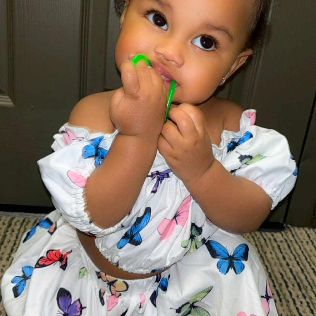 Kassidy joined the competition — help win amazing prizes! accessories, baby, bodypart, brush, clothing, cutlery, dress, face, finger, food, hand, head, mouth, person, photography, portrait, sitting, spoon, sweets, teeth