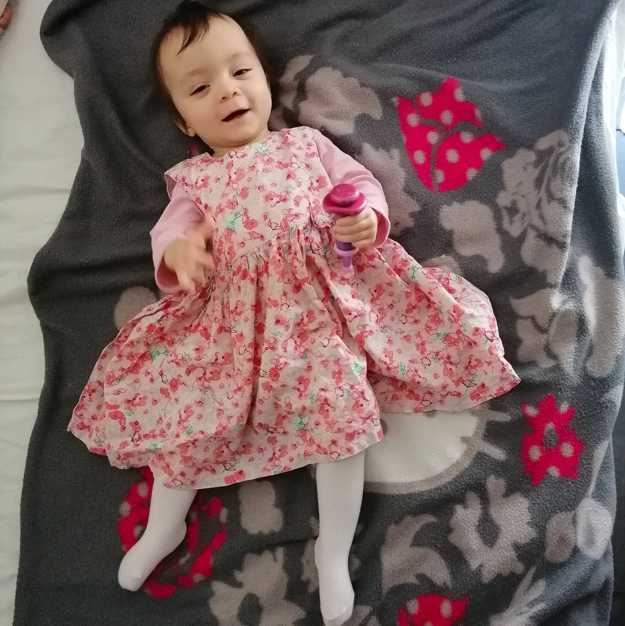 Maïly participe au concours pour gagner de l'argent avec cette photo : baby, baby_toddler_clothing, cheek, collar, comfort, day_dress, dress, face, gesture, happy, head, neck, one_piece_garment, outerwear, person, pink, skin, sleeve, smile, textile