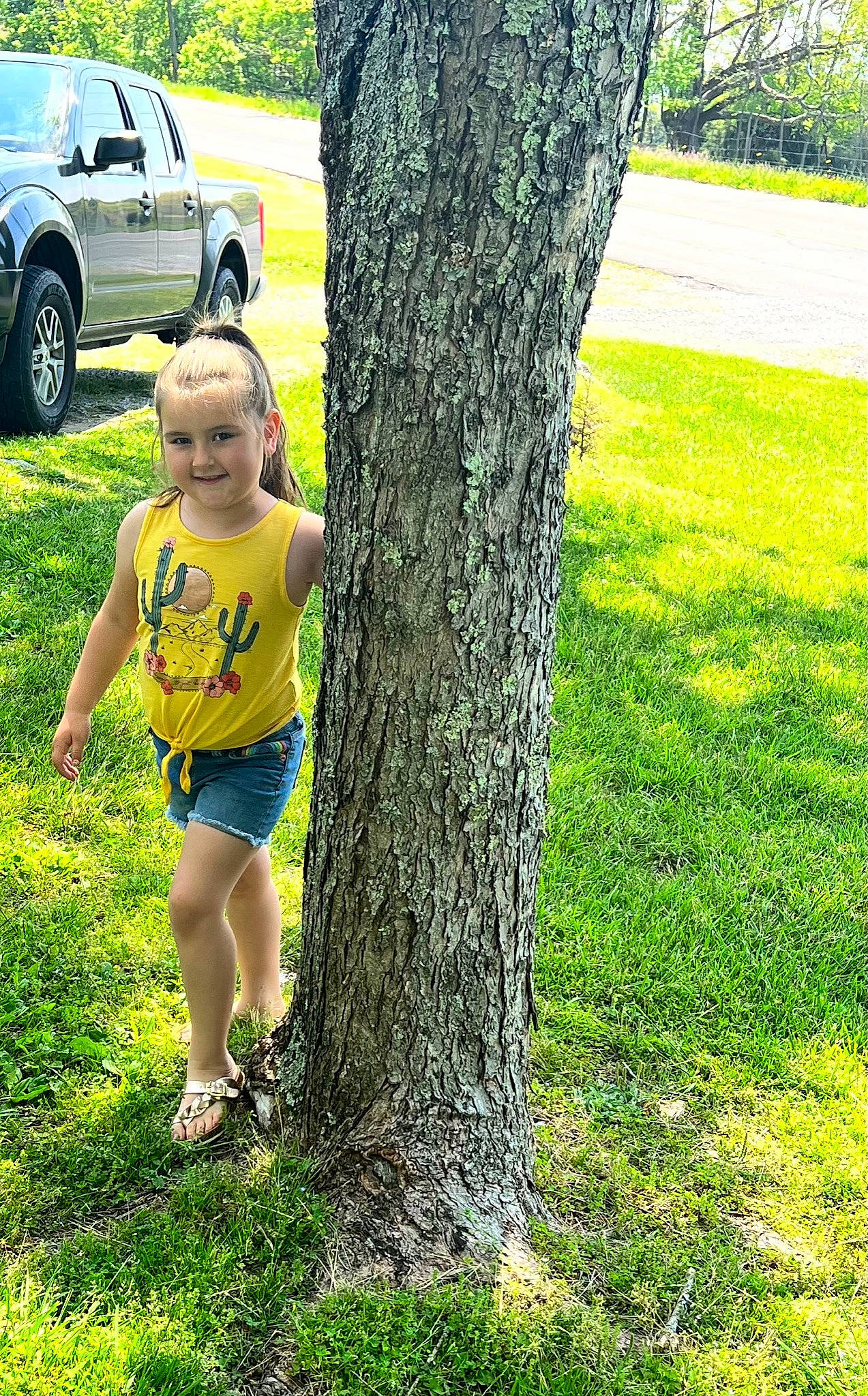 Sarai joined the competition — help win amazing prizes! automotive_tire, car, grass, green, groundcover, happy, joy, motor_vehicle, nature, people_in_nature, person, plant, t_shirt, thigh, tire, tree, trunk, vehicle, vehicle_door, wheel