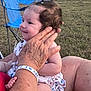 June is registered to the contest to win money with this photo: baby, child, smiling, person, hand, wristband, outdoor, grass, chair, blue, holding, cute, hair, dress, sitting, skin, wrinkles, adult, nature, happy