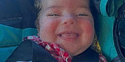 June joined the competition — help win amazing prizes! baby, child, smiling, car_seat, seatbelt, pigtails, red_clothing, checkered_pattern, happy, infant, cute, face, hand, straps, safety, child_seat, person, indoors, closeup, portrait