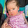 June is registered to the contest to win money with this photo: baby, infant, child, pink_dress, gingham, car_seat, seatbelt, curly_hair, wet_hair, serious_expression, cute, skin, hand, leg, indoors, closeup, person, young_child, sitting, clothing