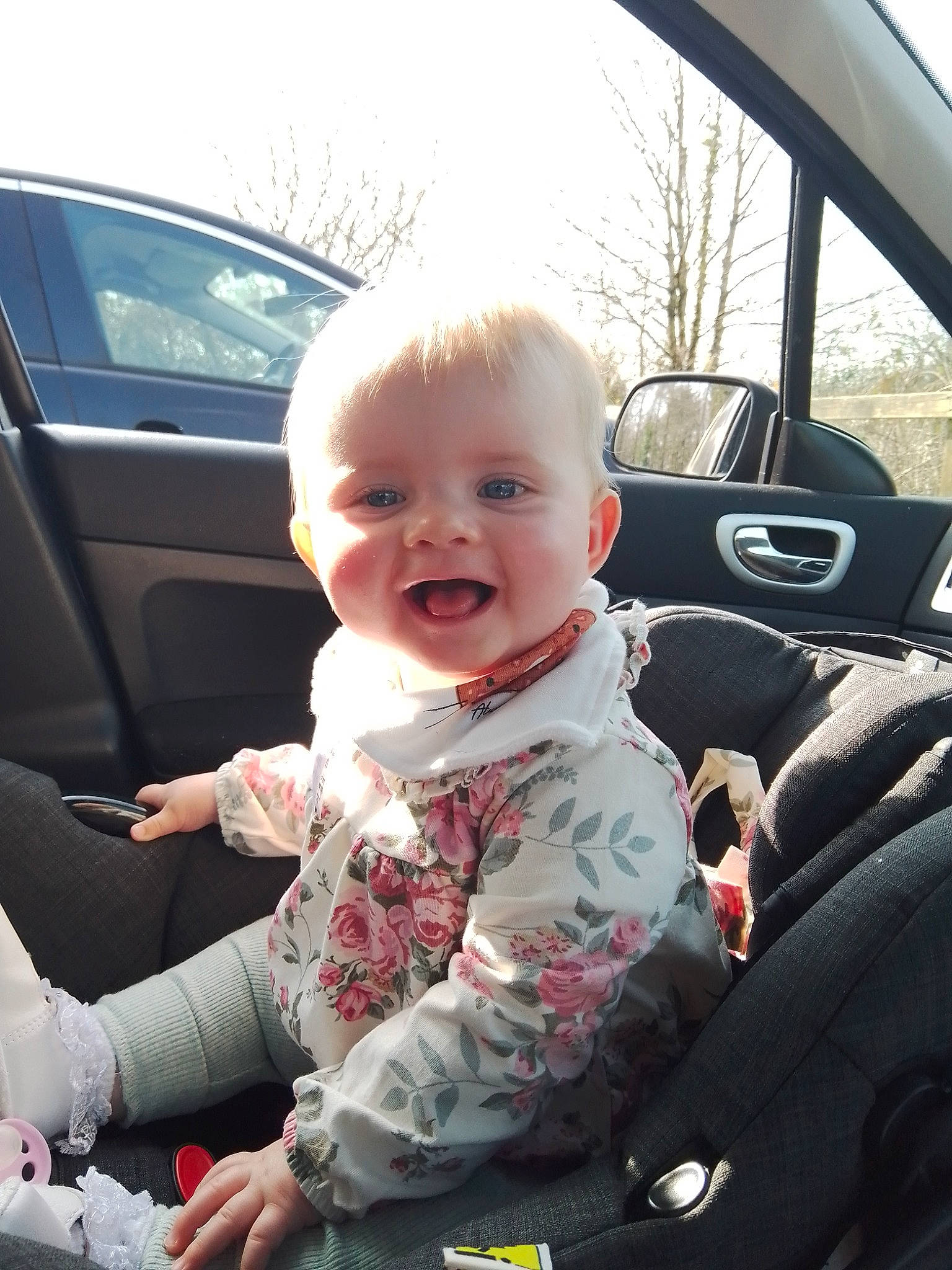 Addison is registered to the contest to win money with this photo: auto_part, automotive_design, automotive_exterior, car, car_seat, hairstyle, happy, mammal, mode_of_transport, motor_vehicle, person, plant, product, sky, smile, steering_part, steering_wheel, toddler, vehicle, vehicle_door