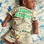 Messiah joined the competition — help win amazing prizes! baby, infant, child, clothing, tshirt, shorts, blanket, soft_texture, pattern, surf_legend, cute, lying_down, skin, foot, hand, face, side_view, indoors, relaxed, portrait