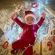 Rylin joined the competition — help win amazing prizes! baby, infant, christmas, holiday, red_onesie, santa_hat, flour, wooden_floor, gingerbread_cookies, cookie_cutters, rolling_pin, christmas_lights, festive, smiling, happy, holiday_baking, indoors, cute, celebration, child