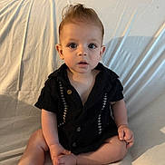 Charlie joined the competition — help win amazing prizes! baby, child, infant, sitting, black_shirt, curly_hair, moawk, indoors, white_background, cute, portrait, looking_at_camera, skin, small_hand, legs, expression, young, one_person, front_view, casual_clothing