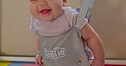 Lily-Rose is registered to the contest to win money with this photo: baby, baby_jumper, blinds, child, clothing, colorful, feet, foam_mat, fun, happy, indoor, infant, legs, person, playmat, playtime, smiling, suspended, window, young_child