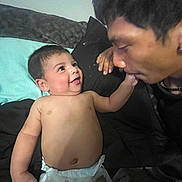 Isaias is registered to the contest to win money with this photo: baby, diaper, smile, person, adult, face, hand, bed, blanket, pillow, interaction, love, affection, indoor, skin, cute, closeup, family, happy, toddler