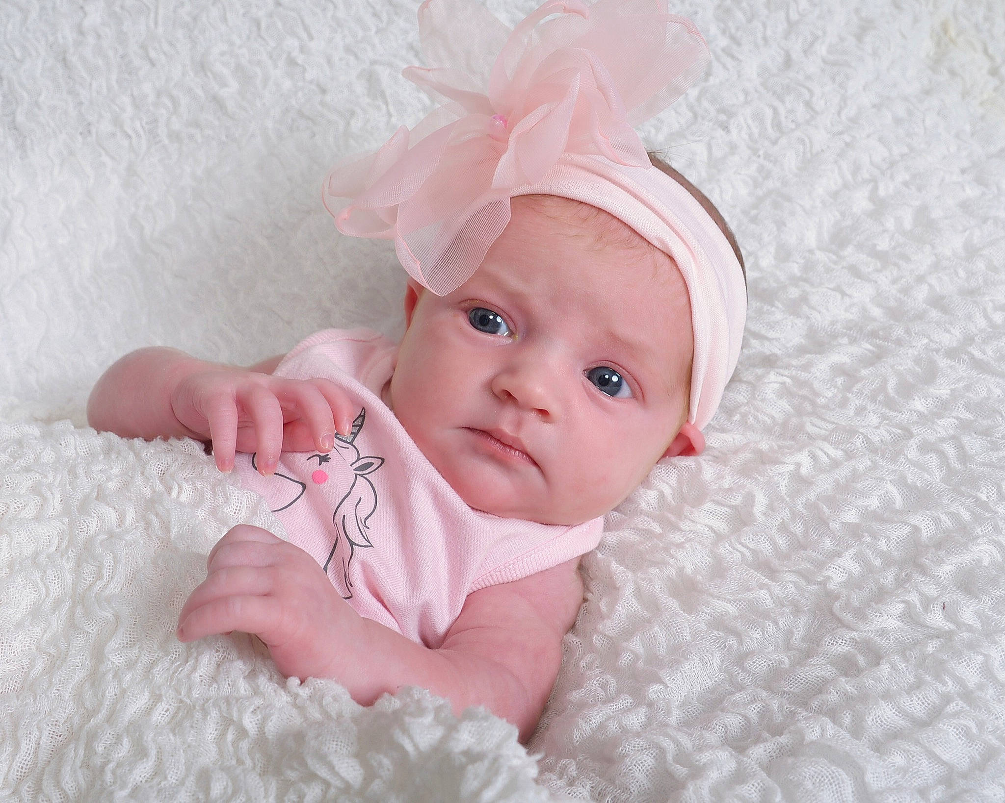 Arizona is registered to the contest to win money with this photo: baby, baby_products, baby_toddler_clothing, cheek, child, eye, face, fur, hair_accessory, hand, head, headgear, lip, person, photograph, pink, product, skin, textile, toddler