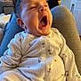 Mila is registered to the contest to win money with this photo: baby, chair, clothing, couch, cushion, face, furniture, head, homedecor, knitwear, person, photoframe, photography, portrait, sweater, yawning