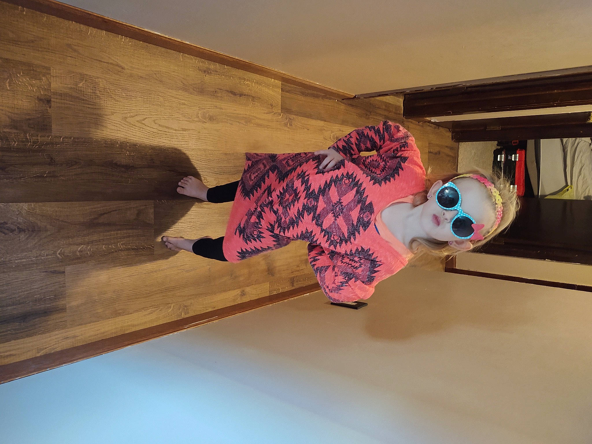 Hailey is registered to the contest to win money with this photo: ceiling, child, floor, flooring, hardwood, helmet, leisure, magenta, pattern, person, personal_protective_equipment, plywood, room, sock, toddler, toy, visual_arts, window, wood, wood_flooring