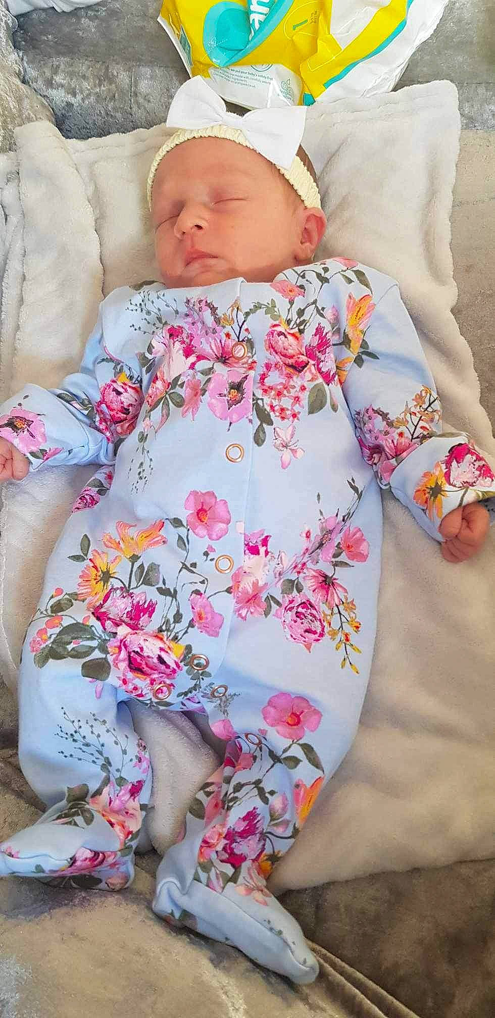 Arianna is registered to the contest to win money with this photo: baby, baby_sleeping, baby_toddler_clothing, child, collar, comfort, linens, lip, pattern, peach, person, pink, plant, skin, sleeve, t_shirt, textile, thigh, toddler, waist