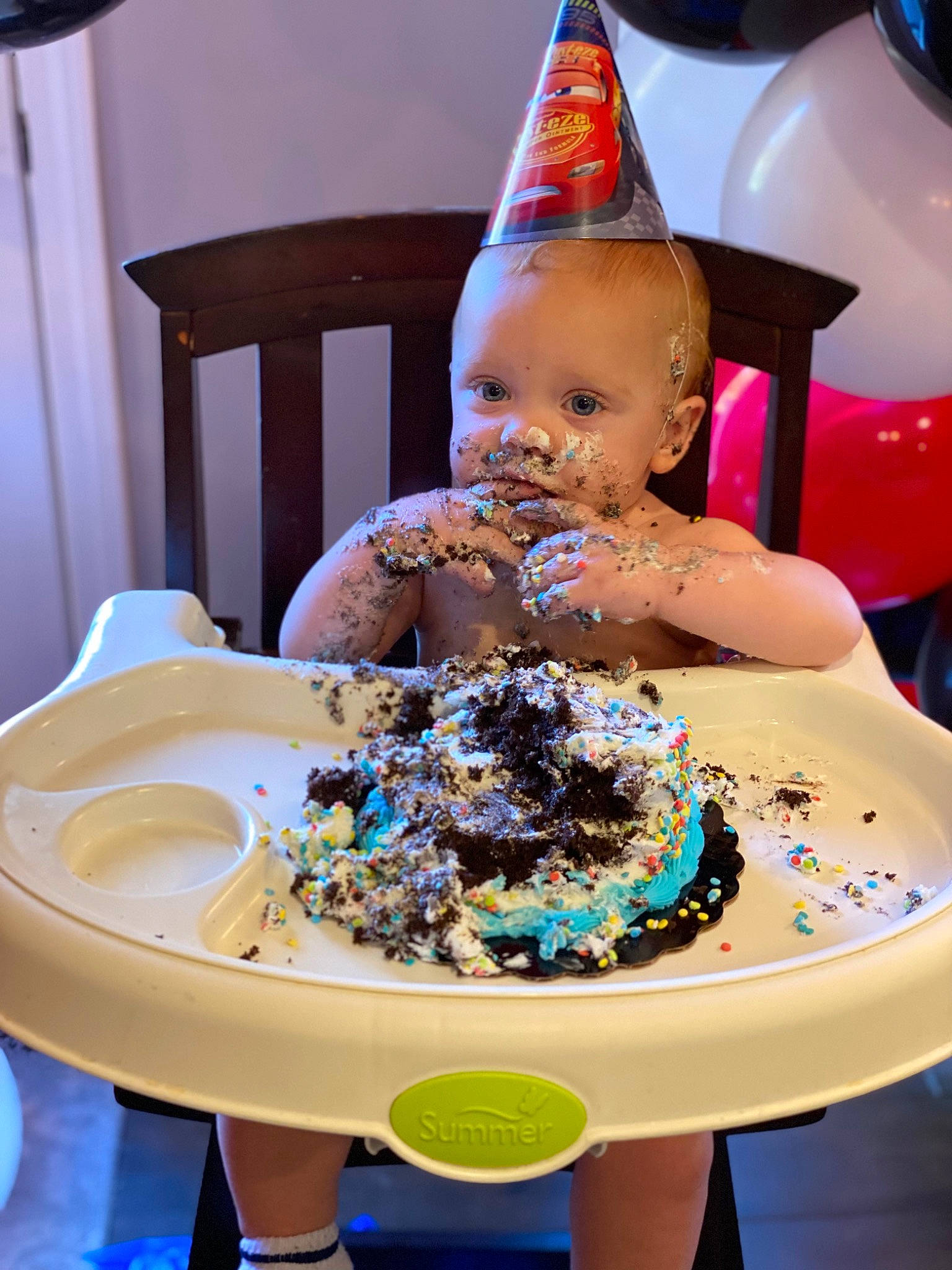 Fletcher is registered to the contest to win money with this photo: baked_goods, birthday, blue, buttercream, cake, cake_decorating, cake_decorating_supply, chair, food, icing, ingredient, party_hat, party_supply, person, plate, recipe, sugar_cake, sugar_paste, table, tableware