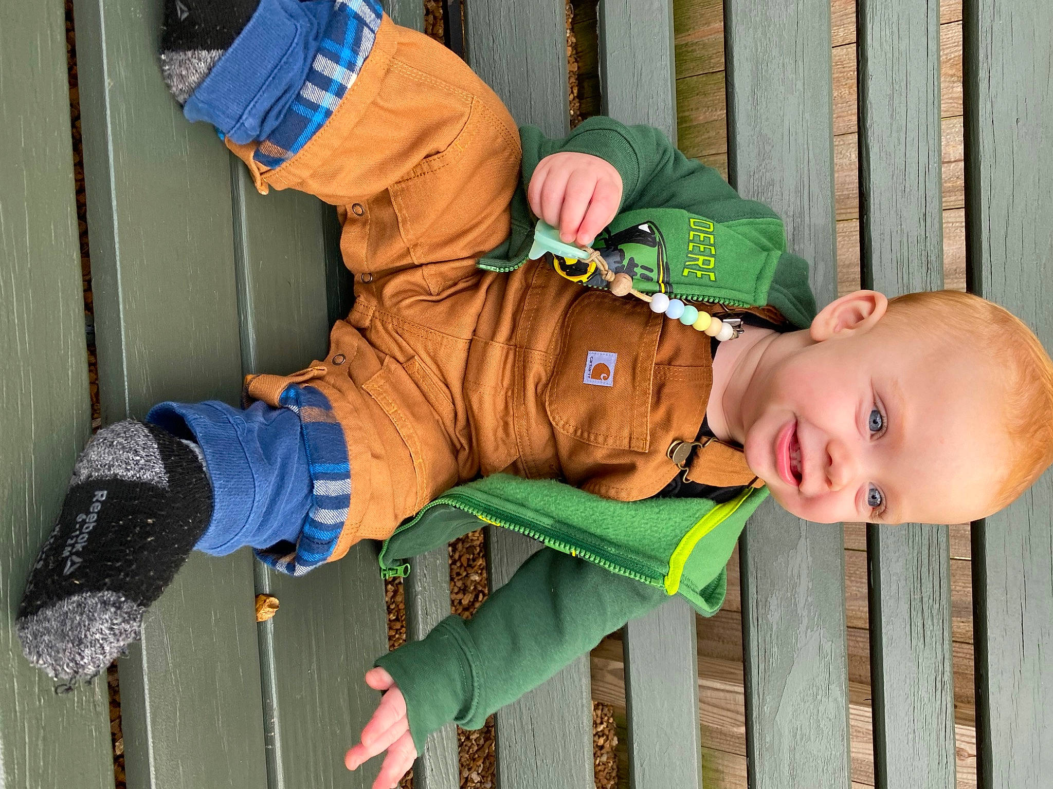 Fletcher joined the competition — help win amazing prizes! baby, baby_toddler_clothing, child, electric_blue, fence, fun, glove, grass, green, happy, hat, jacket, leisure, outerwear, person, personal_protective_equipment, sitting, sleeve, toddler, windbreaker