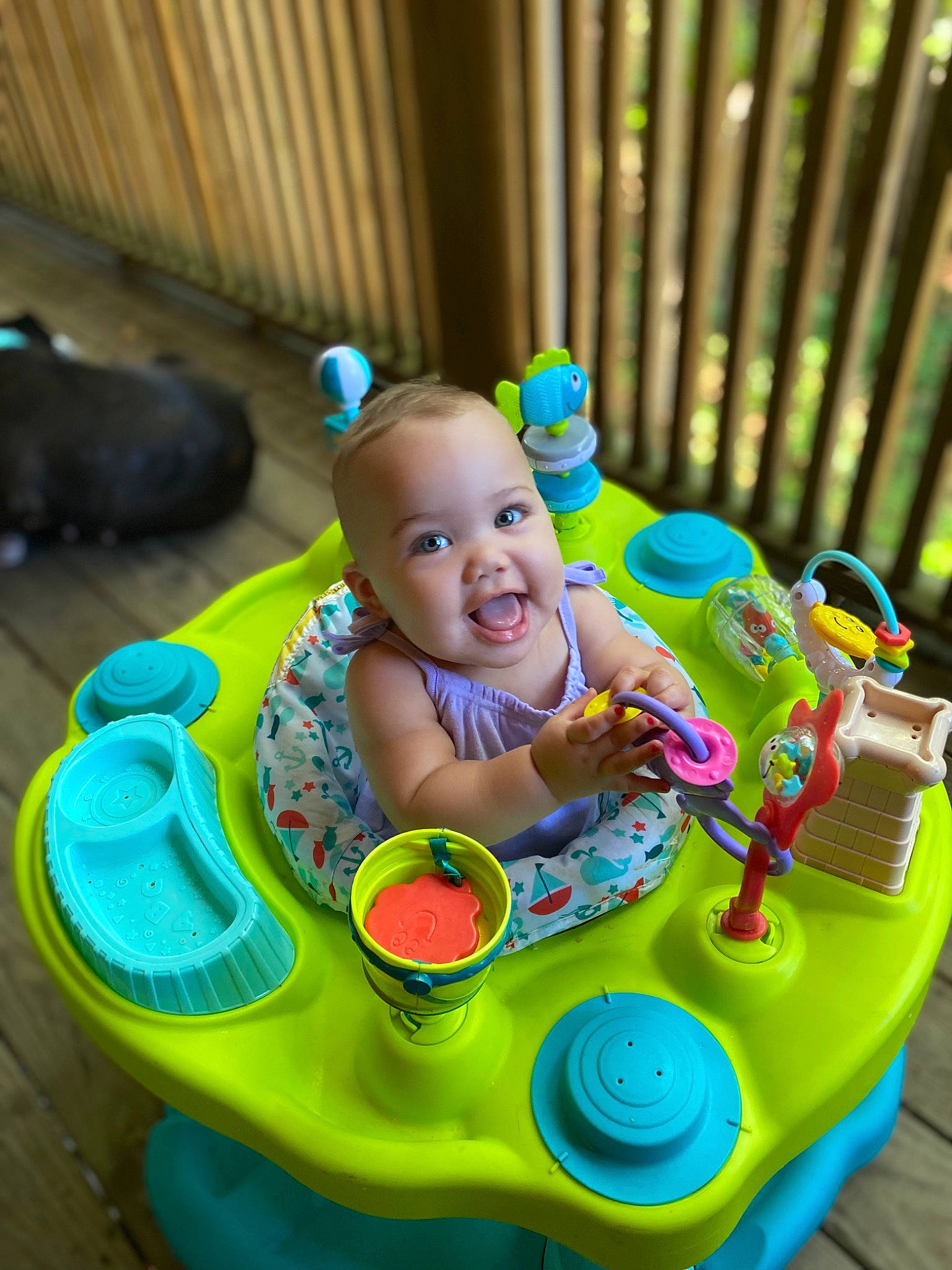 Nayana is registered to the contest to win money with this photo: baby, baby_playing_with_toys, baby_products, baby_toddler_clothing, baby_toys, child, flooring, fun, green, happy, leisure, person, play, recreation, riding_toy, sitting, smile, toddler, toy, toy_vehicle