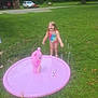 child, girl, swimsuit, water, sprinkler, inflatable, care_bears, grass, lawn, outdoor, summer, play, fun, smiling, happy, tree, shed, car, toy, nature