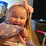 Skylar joined the competition — help win amazing prizes! toddler, child, girl, headband, makeup, palette, smile, happy, indoors, sweater, toy, face, cheeks, glitter, scooter, furniture, living_room, hair, playful, cozy