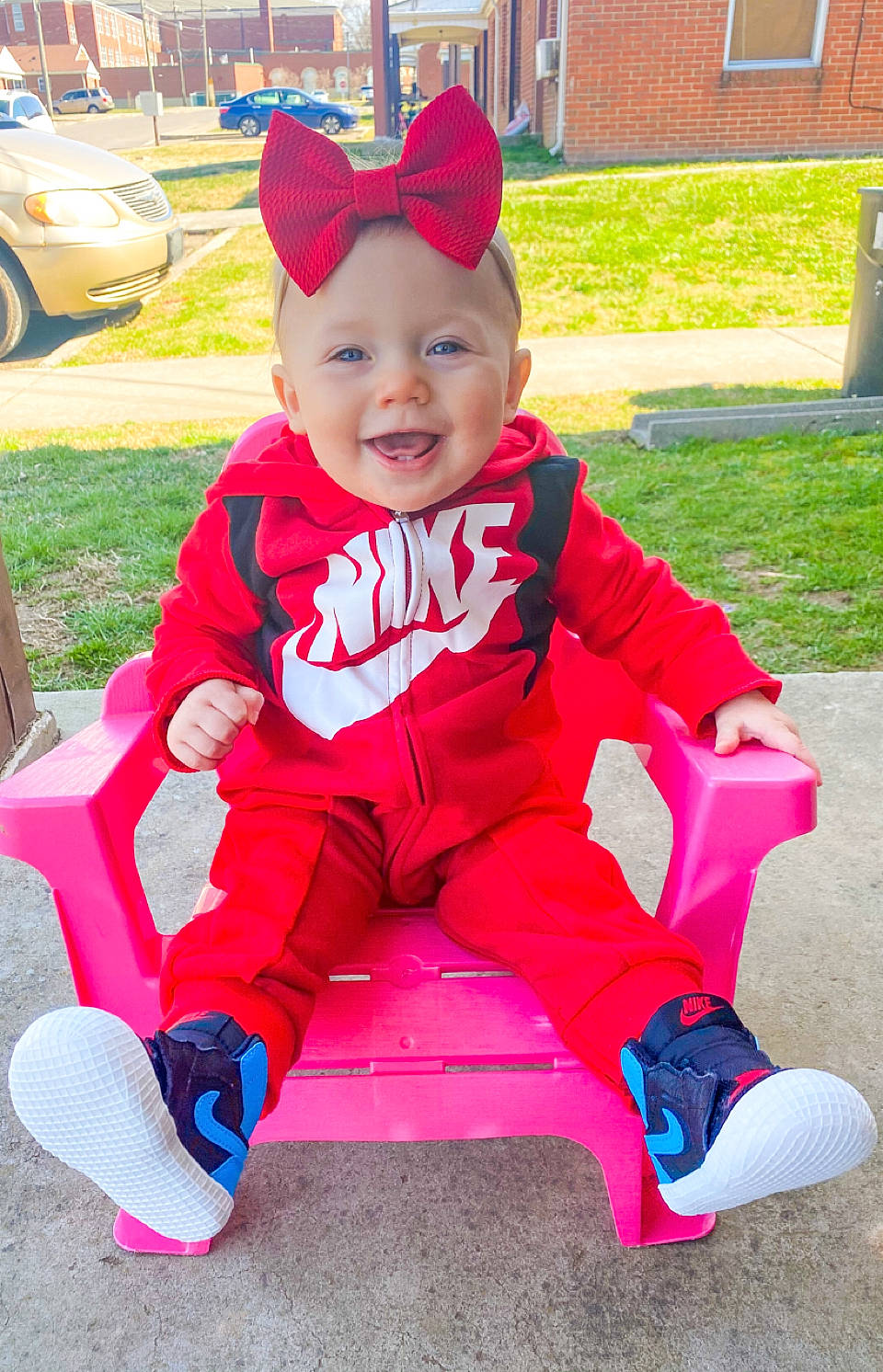 Natalee joined the competition — help win amazing prizes! baby, baby_toddler_clothing, cap, fun, grass, happy, headwear, leisure, magenta, person, pink, plant, purple, recreation, red, shoe, sleeve, smile, t_shirt, tire