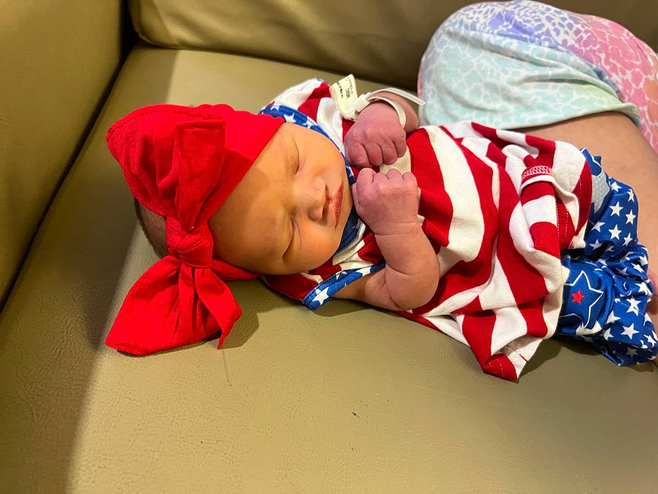 Avalynn is registered to the contest to win money with this photo: abdomen, arm, baby, baby_products, baby_sleeping, baby_toddler_clothing, carmine, comfort, couch, event, fashion_accessory, glasses, hand, happy, hat, headwear, human_body, human_leg, linens, person