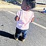 Karizma joined the competition — help win amazing prizes! child, toddler, back_view, standing, parking_lot, pavement, shadow, pink_shirt, jeans, sneakers, afro_hair, hair_bun, curb, desert_plant, sunlight, outdoor, candid, side_profile, parking_space, vehicle