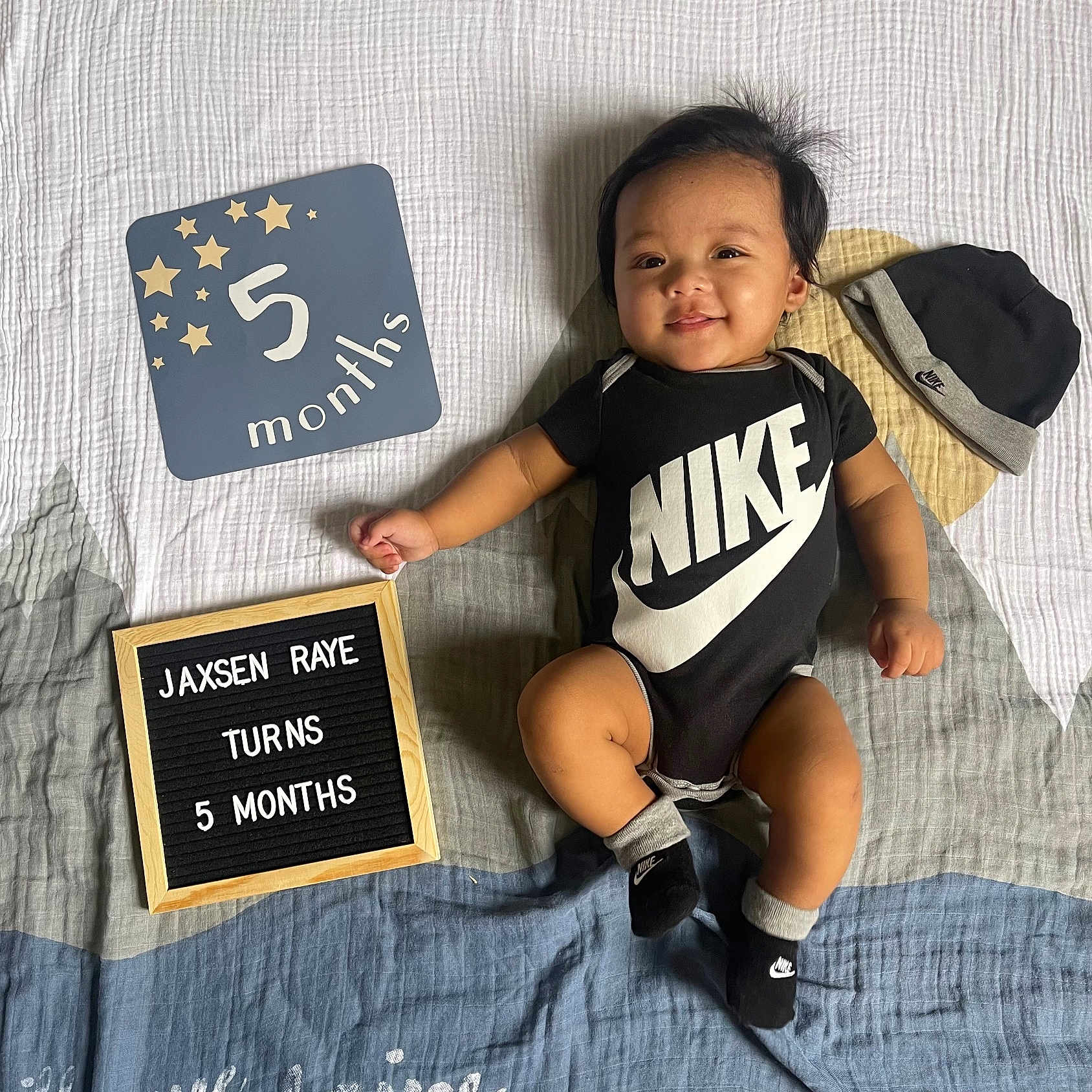 Jaxsen Raye is registered to the contest to win money with this photo: advertisement, baby, babylaughing, clothing, creditcard, face, furniture, happy, head, hosiery, number, people, person, photography, portrait, sitting, sock, symbol, t_shirt, text