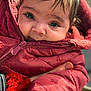 Rose is registered to the contest to win money with this photo: baby, child, close_up, cute, expression, eyes, face, hand, infant, jacket, knitwear, outdoor, person, portrait, red, skin, soft, warm_clothing, winter, zipper