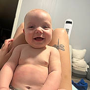 Knox joined the competition — help win amazing prizes! baby, smiling, child, infant, person, tattoo, leg, hand, diaper, indoor, room, fan, cushion, furniture, skin, happy, cute, chubby, sitting, portrait