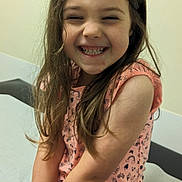 Annie joined the competition — help win amazing prizes! blouse, bodypart, child, clothing, couch, dress, face, female, furniture, girl, happy, head, laughing, mouth, person, photography, portrait, sitting, smile, teeth