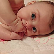 Annie is registered to the contest to win money with this photo: baby, infant, face, hand, fingers, blanket, lying_down, skin, cute, child, young, portrait, closeup, soft, resting, bed, sleepwear, expression, newborn, warm