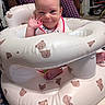 Aurora joined the competition — help win amazing prizes! baby, infant, smiling, waving, inflatable_seat, teddy_bear_pattern, indoor, person, plaid_pajamas, foot, bib, happy, child, cute, seat, floor, carpet, hand, face, head