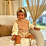Zoé a rejoint le concours — aidez-le/la à gagner de superbes lots ! armchair, child, clothing, cozy, curtains, cute, daylight, flower, girl, headband, home, indoor, knitwear, lamp, shoes, shorts, sitting, smile, socks, window