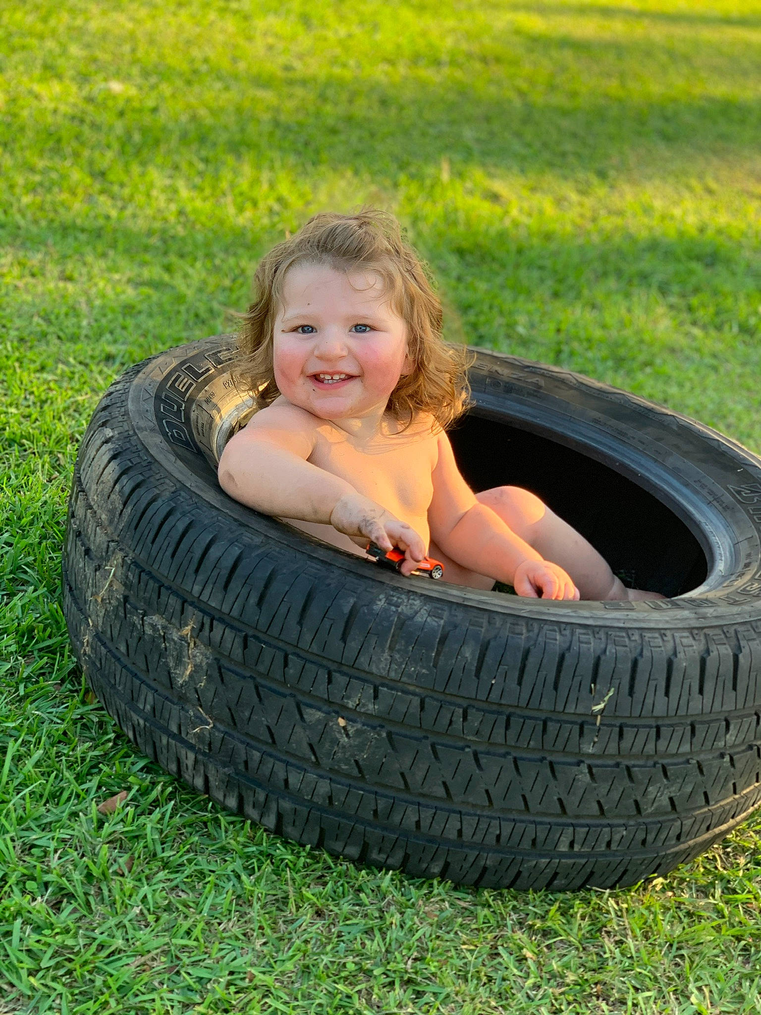 Mia joined the competition — help win amazing prizes! automotive_design, automotive_tire, automotive_wheel_system, fun, grass, grass_family, happy, joy, lawn, leisure, mammal, people_in_nature, person, plant, rim, smile, synthetic_rubber, tire, tire_care, toddler