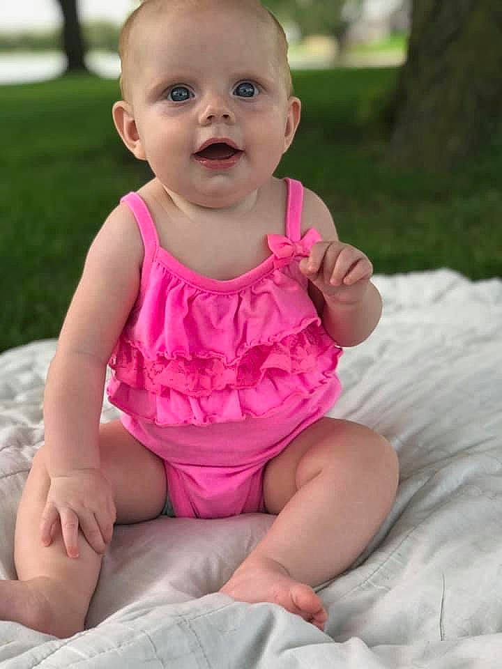 Porter joined the competition — help win amazing prizes! baby, baby_toddler_clothing, cheek, child, dress, eye, face, finger, grass, head, leg, lip, nose, person, pink, play, sitting, skin, smile, summer