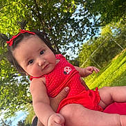 Anaya Rose is registered to the contest to win money with this photo: baby, child, outdoor, greenery, trees, sunlight, red_clothing, pigtails, bows, cute, infant, person, hand, grass, nature, daylight, portrait, happy, skin, summer