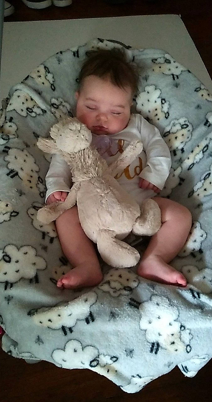 Korra is registered to the contest to win money with this photo: baby, baby_products, baby_sleeping, baby_toddler_clothing, cheek, child, comfort, face, fawn, fur, head, headgear, linens, person, pink, sitting, skin, sleeve, textile, toddler