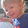 Nataila is registered to the contest to win money with this photo: child, toddler, smiling, indoor, blond_hair, hair_clip, blue_shirt, heart_design, carpet, living_room, person, happy, cute, motion_blur, young_child, portrait, playful, girl, casual_clothing, home